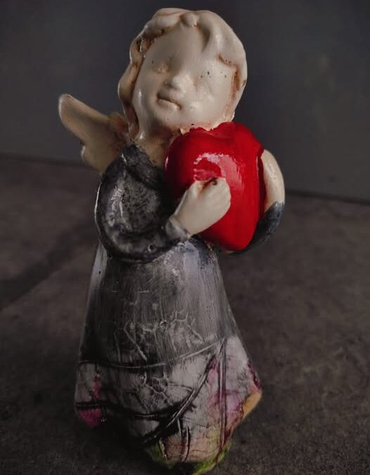 An angel with a heart on his hand